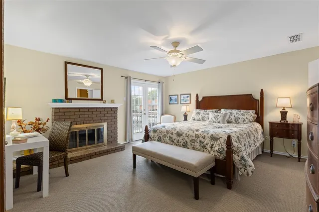 a bedroom with a bed and a fireplace