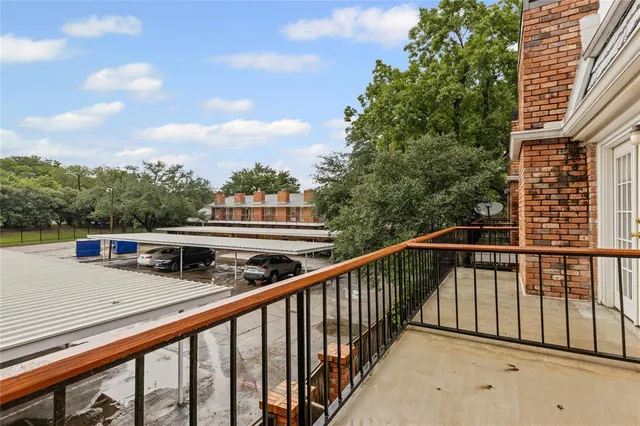 a balcony with trees in front of it