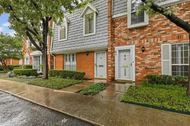 a front view of a house with a yard and a garage