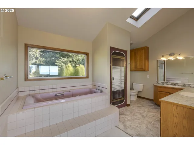 a bathroom with a tub sink and mirror