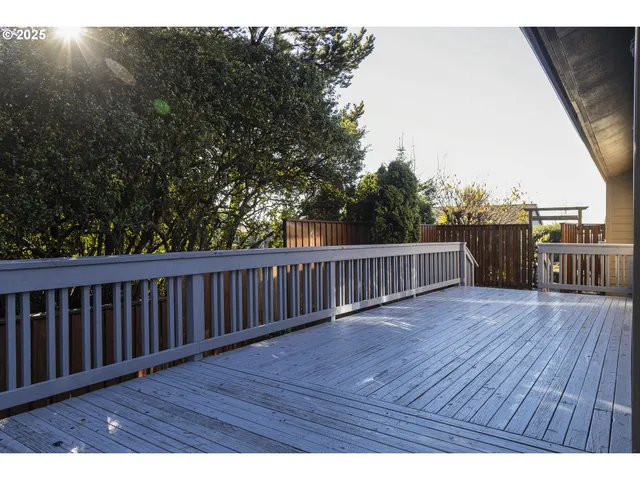 a view of deck with wooden floor and fence