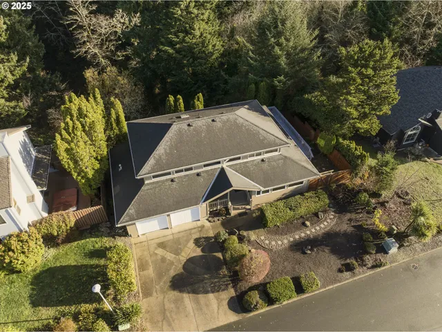 an aerial view of a house with yard swimming pool and outdoor seating