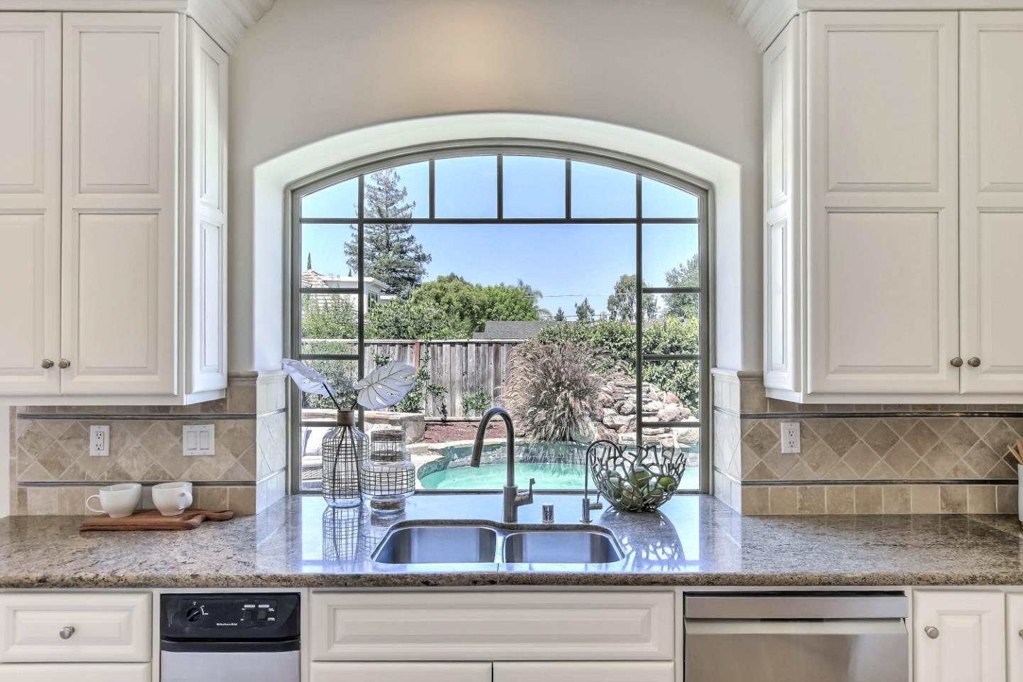 20455 Franklin Avenue Saratoga, CA 95070 - Photo 13 of 44 a kitchen with a granite countertop sink and cabinets