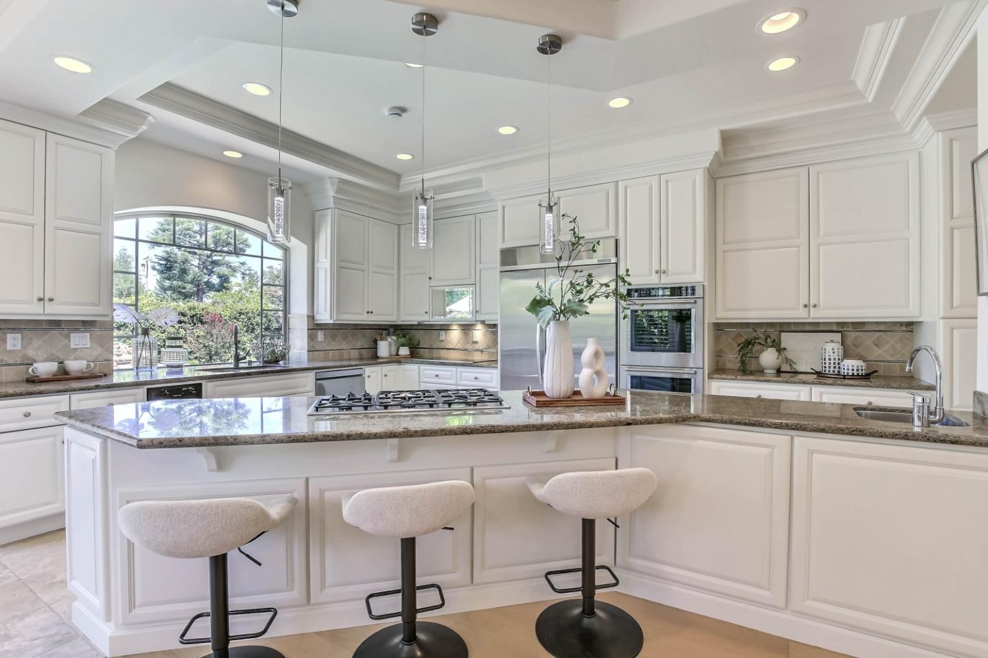 20455 Franklin Avenue Saratoga, CA 95070 - Photo 14 of 44 a kitchen with stainless steel appliances granite countertop a stove a sink and white cabinets with wooden floor