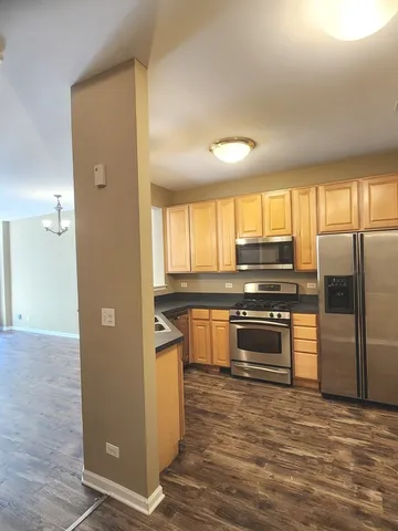 a kitchen with stainless steel appliances granite countertop a refrigerator and a stove top oven