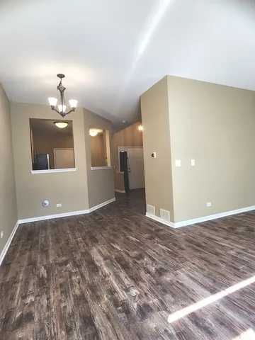 a view of a livingroom with a kitchen