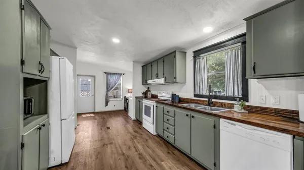 a kitchen with a sink stove and refrigerator