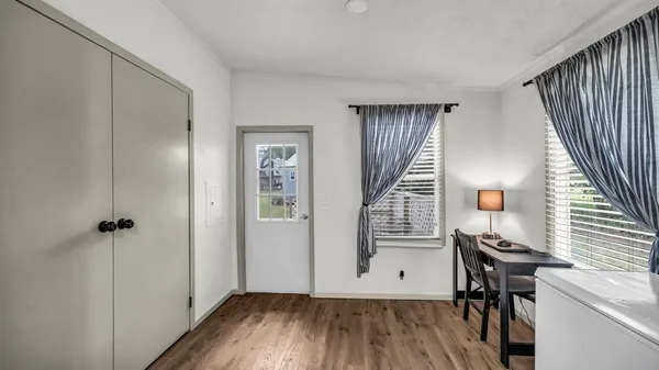 a view of a livingroom with wooden floor and staircase