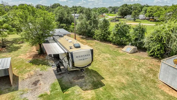 a view of a water fountain with large trees