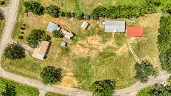 an aerial view of residential house with pool and yard