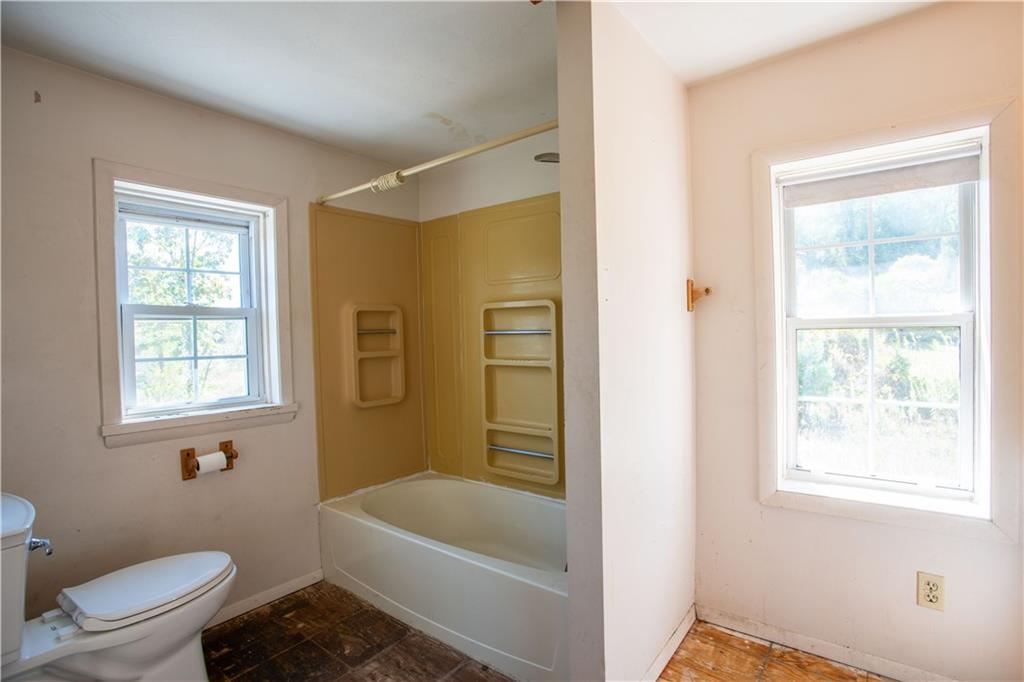 1698 Old Brodhead Road Monaca, PA 15061 - Photo 21 of 34 a bath room with a toilet a bath tub and a window