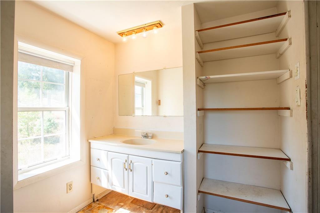 1698 Old Brodhead Road Monaca, PA 15061 - Photo 22 of 34 a bathroom with a sink a mirror and a shower