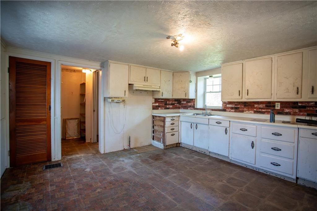 1698 Old Brodhead Road Monaca, PA 15061 - Photo 4 of 34 a kitchen with cabinets appliances and a window