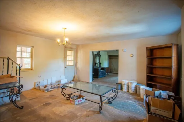 a room with furniture pool table and window