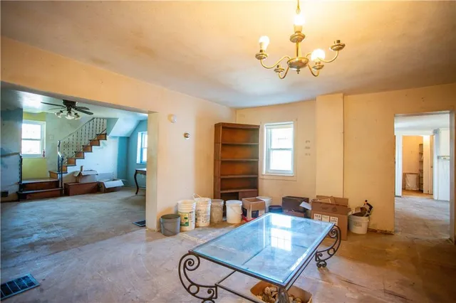 a view of a a dining room with furniture window and wooden floor