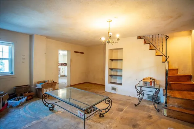 a living room with furniture a dining table and a piano