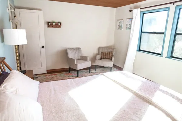 a bed room with a bed and a chair