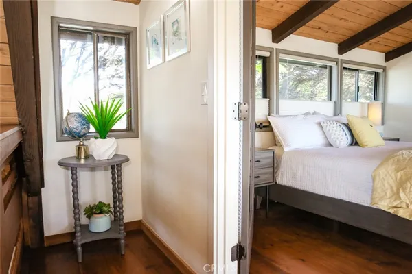 a bedroom with a bed and a large mirror