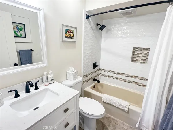 a room with a washing machine and wooden floor