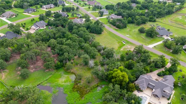 an aerial view of residential houses with outdoor space and street view