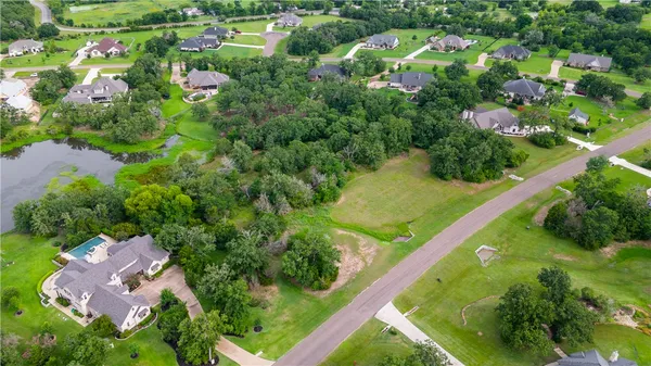 an aerial view of residential houses with outdoor space and street view