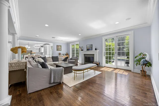 a living room with fireplace furniture and a wooden floor