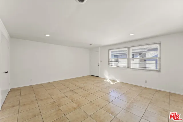 a view of an empty room and a window