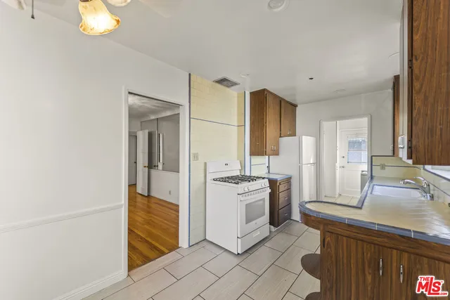 a kitchen with stainless steel appliances granite countertop a refrigerator and a sink