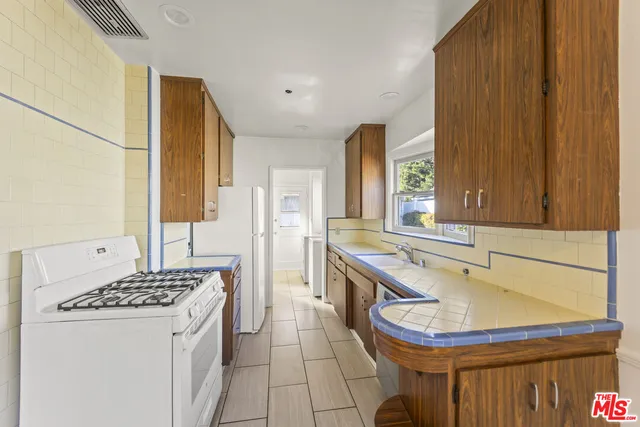 a kitchen with a sink stove and cabinets