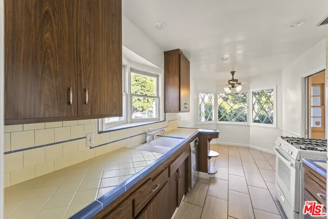 a kitchen with a sink and a stove top oven