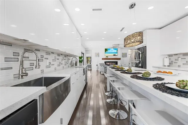 a large kitchen with stainless steel appliances lots of counter space and a sink