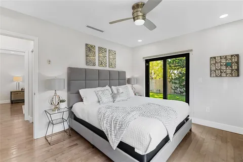 a bedroom with a large bed and a chandelier