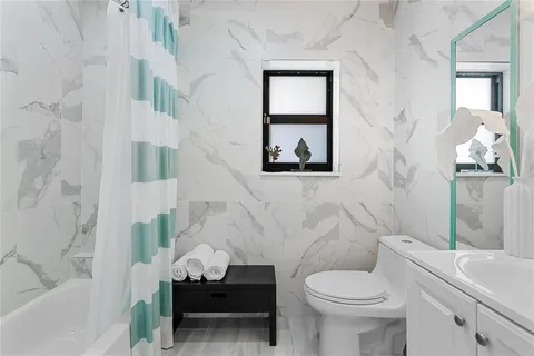 a bathroom with a toilet sink and a bathtub