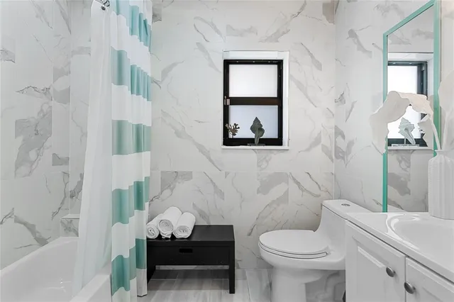 a bathroom with a toilet sink and a bathtub