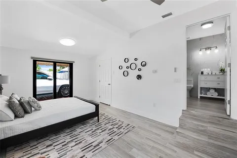 a bedroom with a large bed and a window