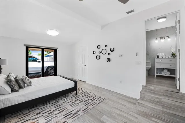 a bedroom with a large bed and a window