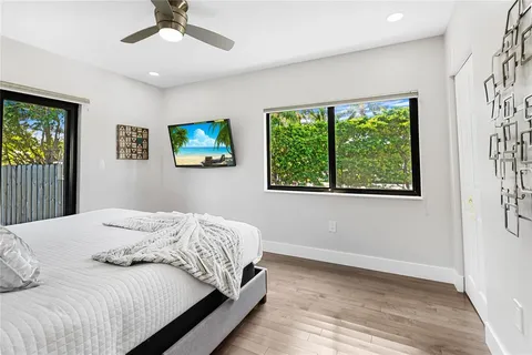 a bedroom with a large bed and a window