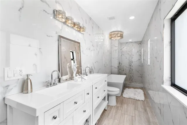 a bathroom with a double vanity sink mirror and shower
