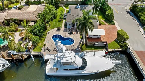 an aerial view of a house with yard swimming pool and outdoor seating