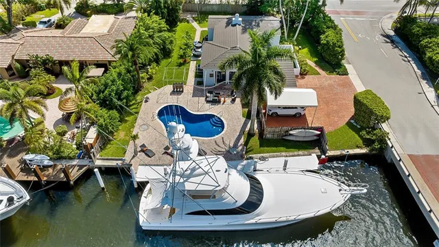 an aerial view of a house with yard swimming pool and outdoor seating