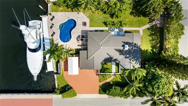 an aerial view of a house with garden space and a yard