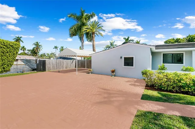 a view of a house with a backyard and a garden