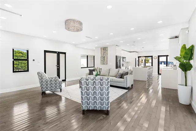 a living room with furniture and wooden floor