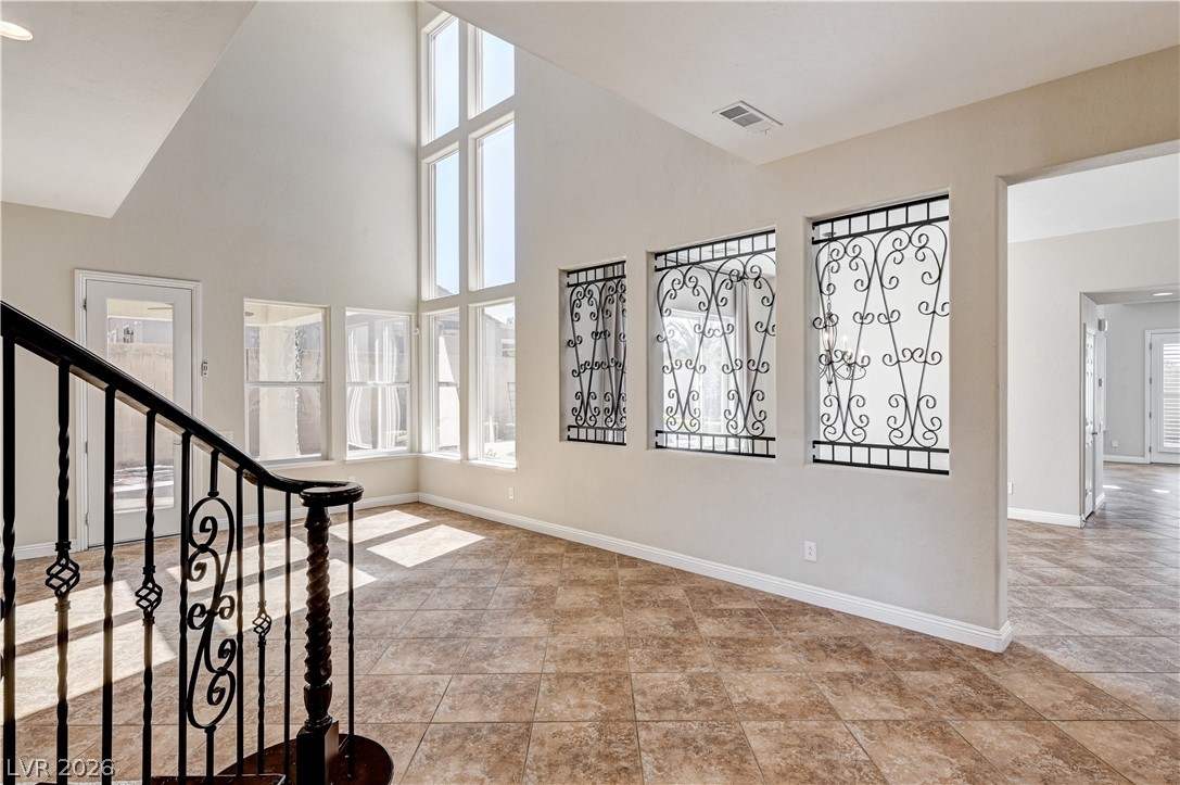 2793 Rosenhearty Drive Henderson, NV 89044 - Photo 24 of 85 A grand entry with soaring ceilings and decorative ironwork provides a striking welcome.