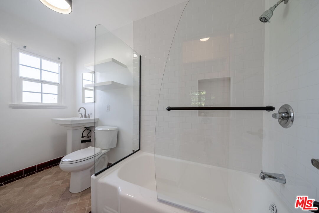 823 Highland Avenue, Unit 2 Glendale, CA 91202 - Photo 2 of 5 a bathroom with a bathtub and a toilet