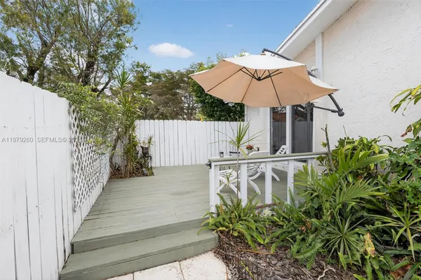 a hallway with painting on the wall and a rug