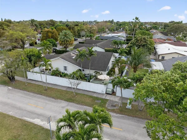 a view of a hallway with wooden floor and furniture