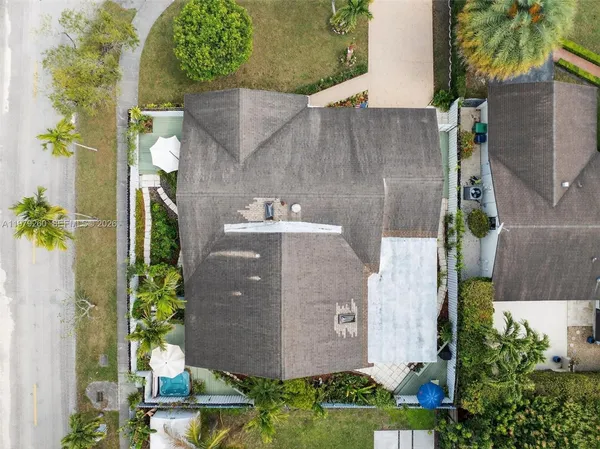 a bedroom with a bed a bookshelf and a window