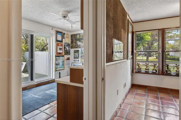 a view of a dining room with furniture and a chandelier