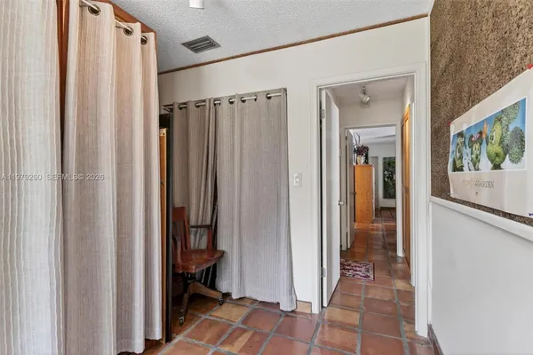 a living room with furniture kitchen view and a chandelier